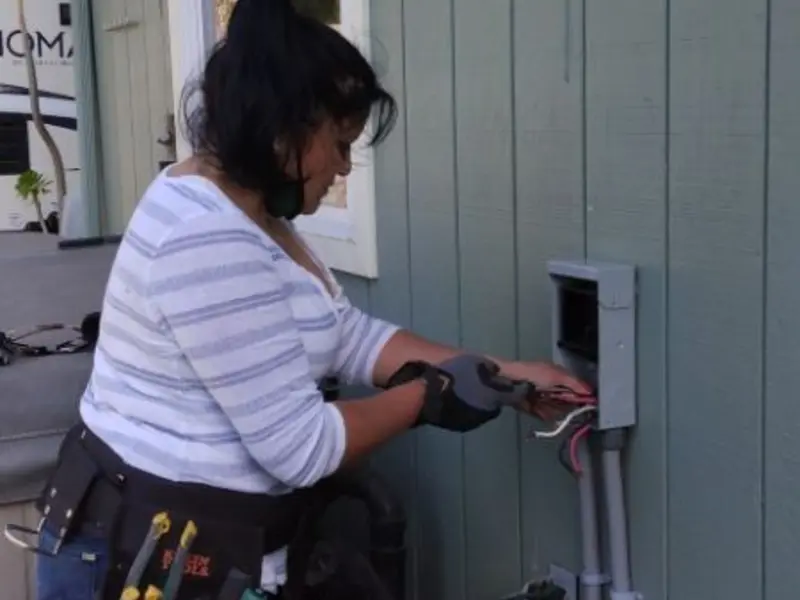 Licensed electrician wiring an exterior subpanel in Hopkins